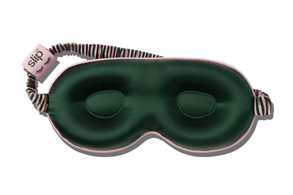 Green contour sleep mask with pink striped strap on a white background
