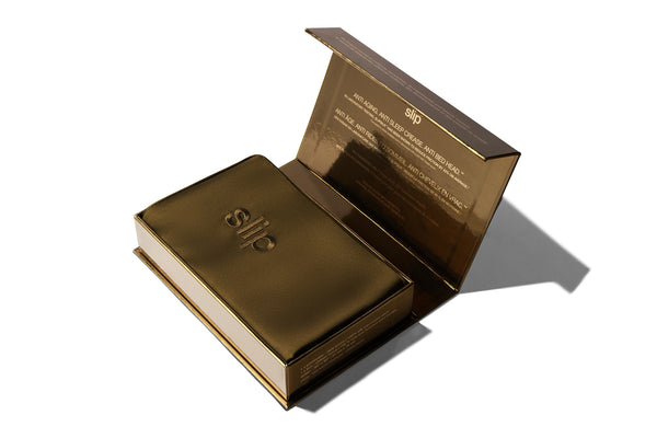 Brown silk pillowcase in packaging on a white background