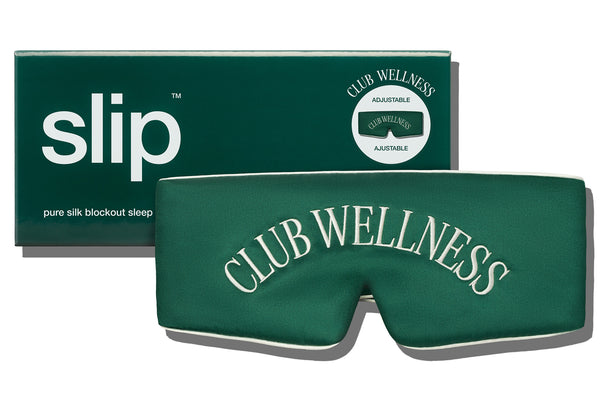 Green blockout sleep mask with 'Club Wellness' embroidery and slip packaging on a white background