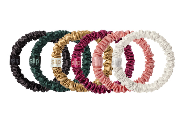 Set of colorful silk scrunchies with 'slip' branding on a white background