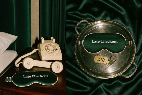 Vintage-style phone and sleep mask with 'Late Checkout' embroidery on a green silk background.