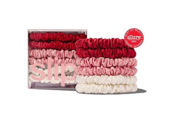 A set of several Slip Silk Hair Scrunchies in various pastel colors.