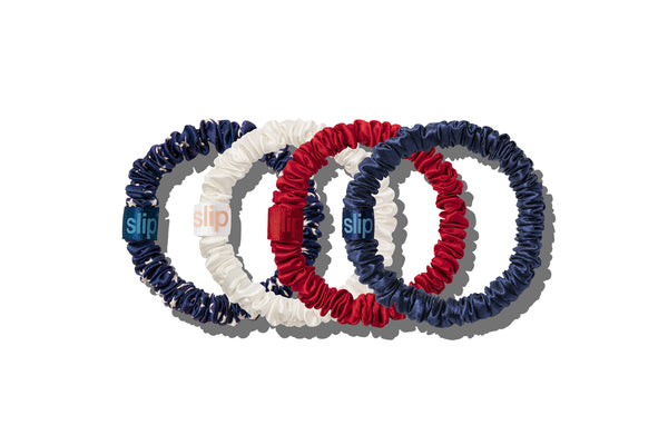 Set of four hair scrunchies in white, red, and navy on a white background